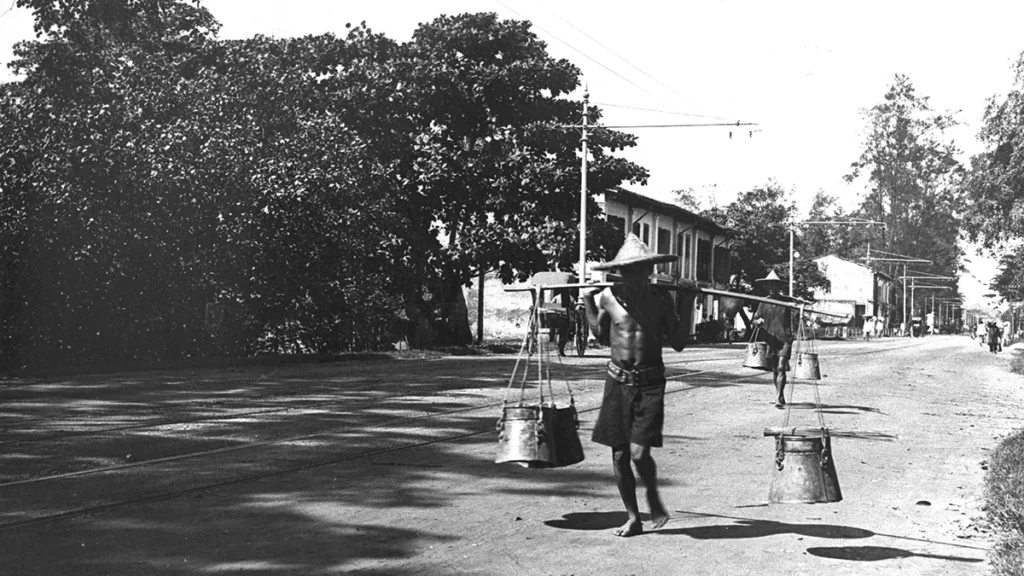 Man Carrying Bucket To Man Pressing Button